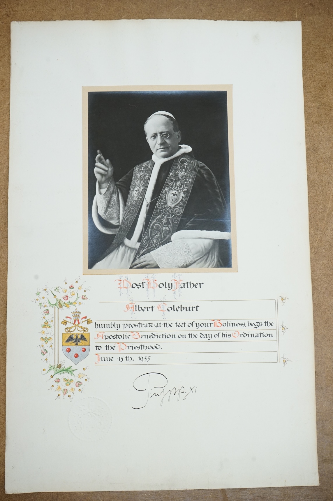 An autographed photograph of Pope Pius XI, on the celebration of the ordination of Albert Coleburt, priested on June 15th, 1935, decorated with the people coat of arms and embossed with Pius XI’s official blind stamp, 52
